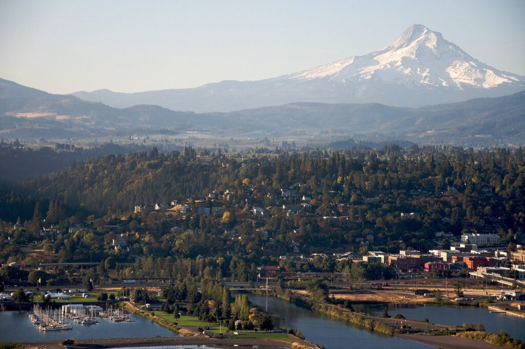 Hood River's hillside town and marina on the Columbia River, with snow-capped Mount Hood rising behind